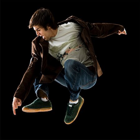 simsearch:640-02656983,k - young man jumping in the air. Foto de stock - Sin royalties Premium, Código: 640-02655741