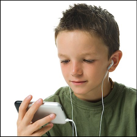 Boy listening to MP3 player. Stock Photo - Premium Royalty-Free, Code: 640-02656161