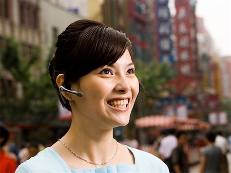 simsearch:640-02949616,k - Woman with a cell phone earpiece. Foto de stock - Royalty Free Premium, Número: 640-02656291