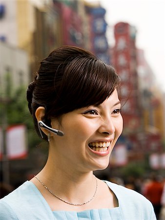 simsearch:640-02949616,k - Woman with a cell phone earpiece. Foto de stock - Royalty Free Premium, Número: 640-02656292