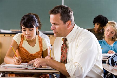 student portrait teacher not smiling - Student and teacher in a classroom. Stock Photo - Premium Royalty-Free, Code: 640-02656573