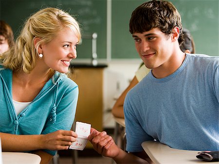 students flirting in classroom - Students passing notes in a classroom. Stock Photo - Premium Royalty-Free, Code: 640-02656607