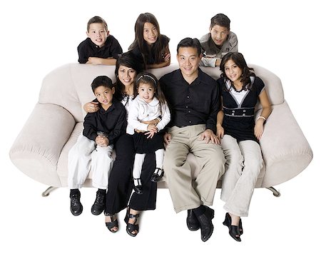 simsearch:640-02776733,k - Family sitting on a couch smiling. Foto de stock - Sin royalties Premium, Código: 640-02656670