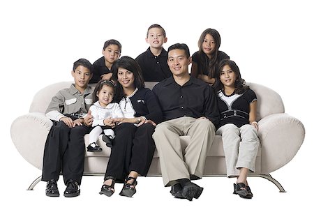 simsearch:640-02776733,k - Family sitting on a couch smiling. Foto de stock - Sin royalties Premium, Código: 640-02656741