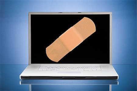 Laptop computer with a Band-aid on the screen. Stock Photo - Premium Royalty-Free, Code: 640-02656945