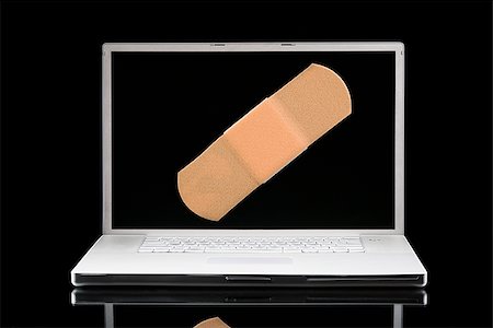 Laptop computer with a Band-aid on the screen. Stock Photo - Premium Royalty-Free, Code: 640-02656946