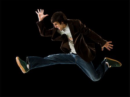 simsearch:640-02656983,k - Young man jumping in the air. Foto de stock - Sin royalties Premium, Código: 640-02656996