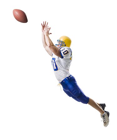 someone catching a football - Young male American football player. Stock Photo - Premium Royalty-Free, Code: 640-02657097