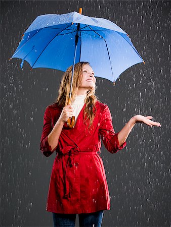 person and raincoat and umbrella - Young woman with an umbrella. Stock Photo - Premium Royalty-Free, Code: 640-02657254