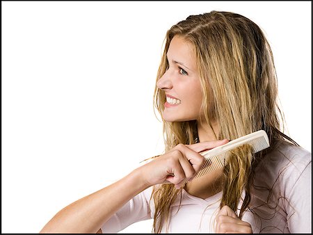 simsearch:640-02655752,k - Young woman combing hair. Stock Photo - Premium Royalty-Free, Code: 640-02657258