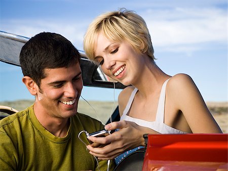 man and woman next to a red convertible Stock Photo - Premium Royalty-Free, Code: 640-02657626