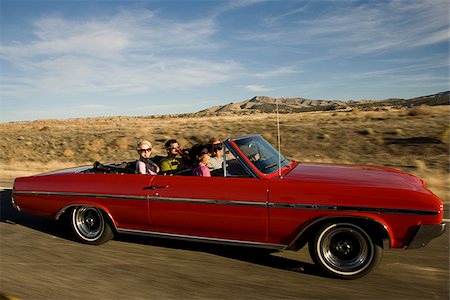 red sunglasses - red car driving down the road Stock Photo - Premium Royalty-Free, Code: 640-02657667