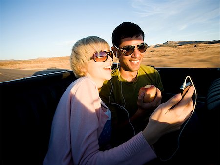 man and woman next to a red convertible Stock Photo - Premium Royalty-Free, Code: 640-02657678