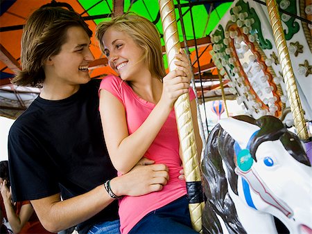 young couple at an amusement park Stock Photo - Premium Royalty-Free, Code: 640-02657776