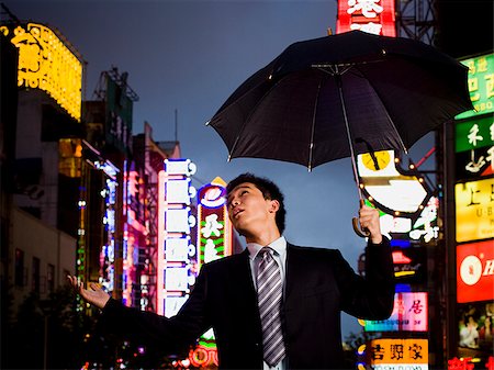 rainy night and single man pic - man with an umbrella Stock Photo - Premium Royalty-Free, Code: 640-02657809