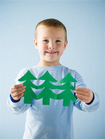 little boy with a paper cutout Stock Photo - Premium Royalty-Free, Code: 640-02657969