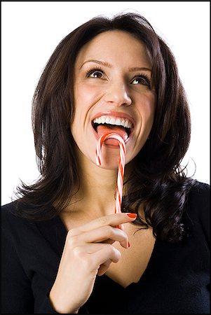 woman licking a candy cane Stock Photo - Premium Royalty-Free, Code: 640-02658086