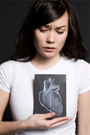 simsearch:640-02658475,k - Woman with a drawing of a heart Foto de stock - Royalty Free Premium, Número: 640-02658470