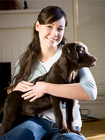 woman and dog in living room Stock Photo - Premium Royalty-Free, Code: 640-02658712