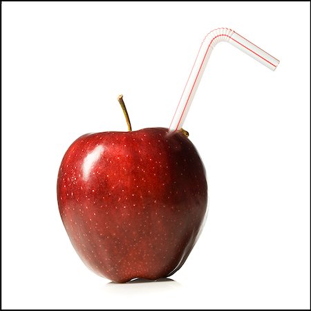 red delicious apple with a straw in it Stock Photo - Premium Royalty-Free, Code: 640-02659087