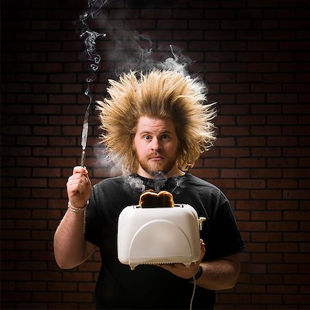 people with electrocuted hair - man with smoking toaster Stock Photo - Premium Royalty-Free, Code: 640-02659274