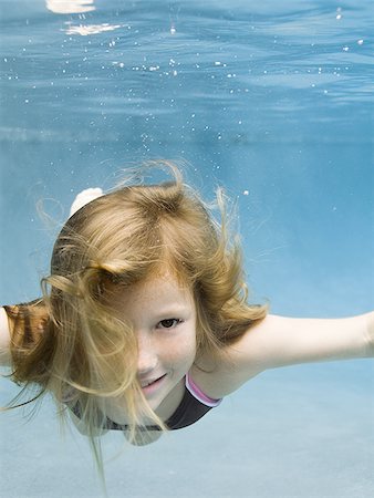 simsearch:640-02764438,k - Portrait of a girl swimming underwater Stock Photo - Premium Royalty-Free, Code: 640-02764435