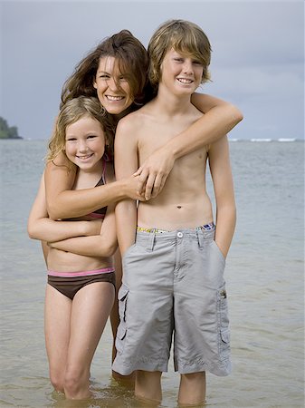 portrait of a boy and his sister standing on the beach - Portrait of a mother embracing her two children Stock Photo - Premium Royalty-Free, Code: 640-02764449