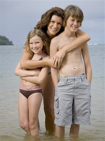 portrait of a boy and his sister standing on the beach - Portrait of a mother embracing her two children Stock Photo - Premium Royalty-Free, Code: 640-02764451