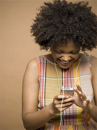 Close-up of a young woman watching a video MP3 player Stock Photo - Premium Royalty-Free, Code: 640-02764533