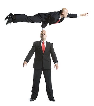 Two male acrobats in business suits performing Stock Photo - Premium Royalty-Free, Code: 640-02764553