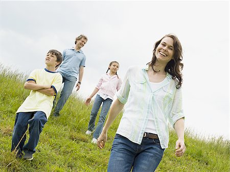 father son walking in field - Family walking in a field Stock Photo - Premium Royalty-Free, Code: 640-02764639