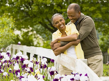 smiling elderly black man - Senior man embracing a senior woman from behind Stock Photo - Premium Royalty-Free, Code: 640-02764667