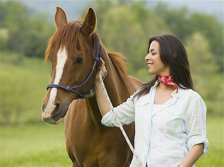 Portrait of a woman standing with a horse Stock Photo - Premium Royalty-Free, Code: 640-02764678