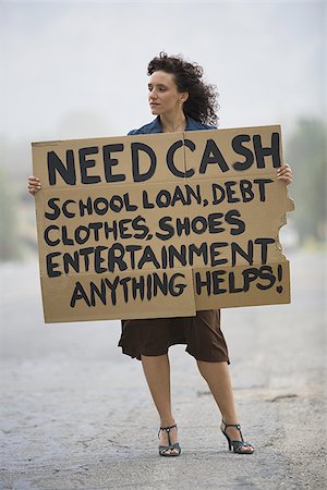 simsearch:640-02767900,k - Young woman holding a help-needed sign Stock Photo - Premium Royalty-Free, Code: 640-02764740