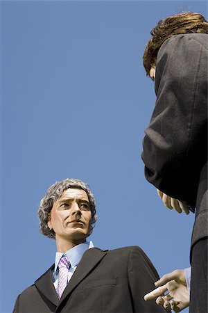 Low angle view of two mannequins portraying businessmen Stock Photo - Premium Royalty-Free, Code: 640-02764801