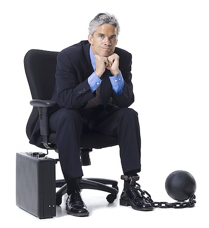 Businessman shackled to ball and chain Stock Photo - Premium Royalty-Free, Code: 640-02764959