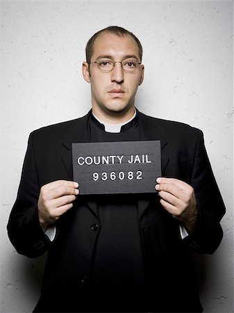 fiend - Mug shot of priest with glasses Stock Photo - Premium Royalty-Free, Code: 640-02765012