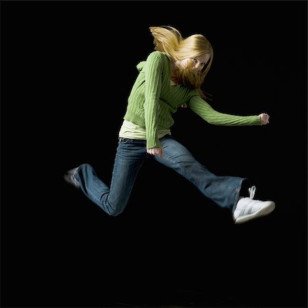 retainer - Girl leaping and smiling Stock Photo - Premium Royalty-Free, Code: 640-02765104