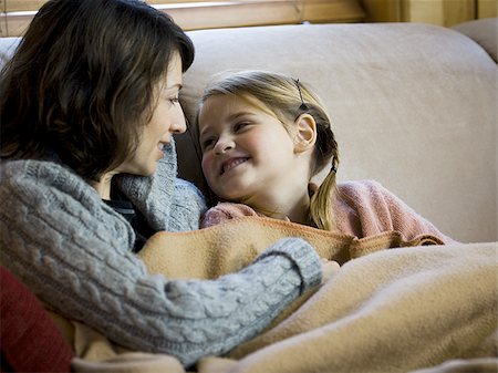 simsearch:640-01601434,k - Woman with young girl snuggling on sofa Stock Photo - Premium Royalty-Free, Code: 640-02765107