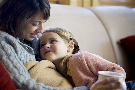 simsearch:640-01601434,k - Woman with young girl snuggling on sofa Stock Photo - Premium Royalty-Free, Code: 640-02765109