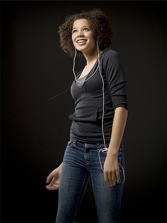 simsearch:640-02775245,k - Girl with braces and MP3 player dancing and smiling Stock Photo - Premium Royalty-Free, Code: 640-02765134