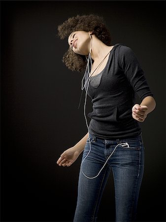 simsearch:640-02775245,k - Girl with braces and MP3 player dancing and smiling Stock Photo - Premium Royalty-Free, Code: 640-02765135