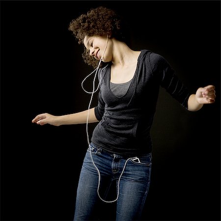 simsearch:640-02773489,k - Girl with braces and MP3 player dancing and smiling Fotografie stock - Premium Royalty-Free, Codice: 640-02765132