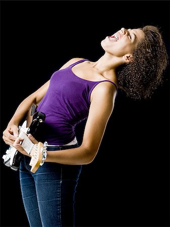 simsearch:640-01363127,k - Girl playing electric guitar and singing Fotografie stock - Premium Royalty-Free, Codice: 640-02765365