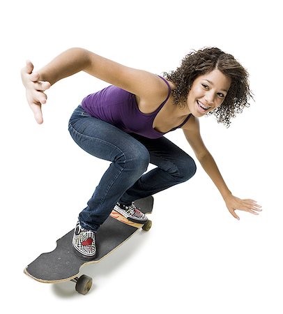 Girl with braces on skateboard smiling Fotografie stock - Premium Royalty-Free, Codice: 640-02765361