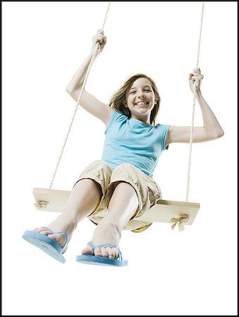 preteen girls flip flops - Portrait of a girl swinging on a rope swing Stock Photo - Premium Royalty-Free, Code: 640-02765904