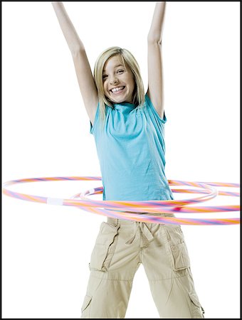 Portrait of a girl playing with a hula hoop Stock Photo - Premium Royalty-Free, Code: 640-02765908