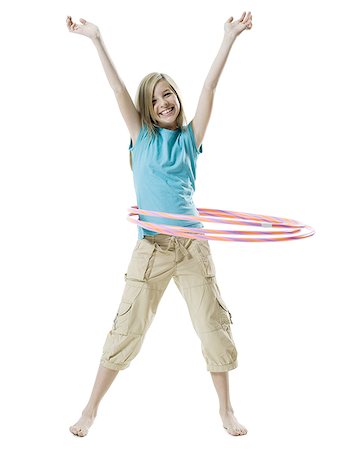 Portrait of a girl playing with a hula hoop Stock Photo - Premium Royalty-Free, Code: 640-02765909