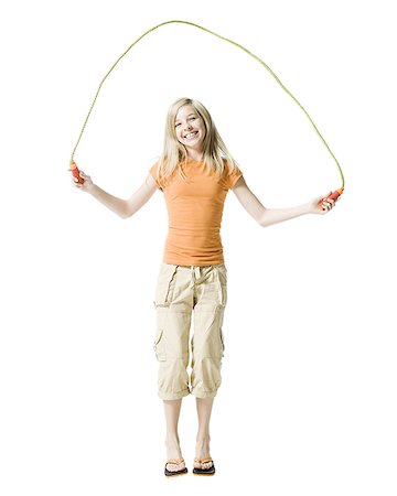 Portrait of a girl jumping rope Stock Photo - Premium Royalty-Free, Code: 640-02765931
