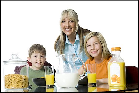 Portrait of a mid adult woman and her two children at the breakfast table Stock Photo - Premium Royalty-Free, Code: 640-02765948